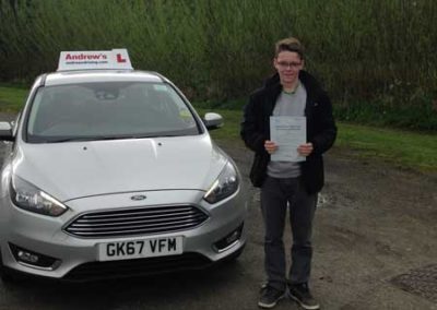 Dylan standing with driving test pass