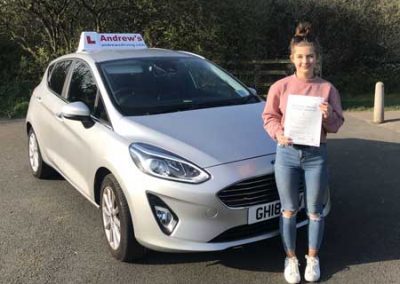 Alys with the driving school car after her Driving Test