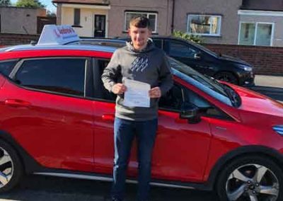 Jamie with his driving instructors car.