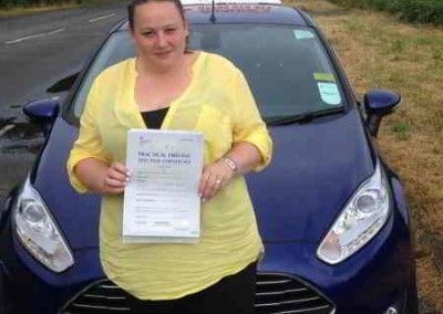 Vicky holding driving test pass certificate after taking driving lessons in Deganwy and llandudno