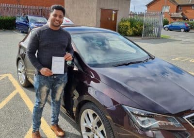 Rins Joseph after passing his driving test with Ryan McCarley in Colwyn Bay