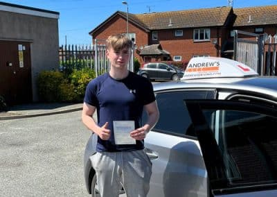 Finlay and his pass certificate at Rhyl Driving Test Centre